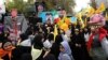 With anti-American slogans and effigies mocking U.S. President Donald Trump, thousands rally outside the former U.S. Embassy in Tehran on November 4.