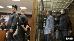 Members of the gang listen to the verdicts in a Moscow court on December 15.