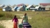 Members of the Roma community walk back home in the village of Pidvynogradiv near the Ukrainian city of Vynogradiv 