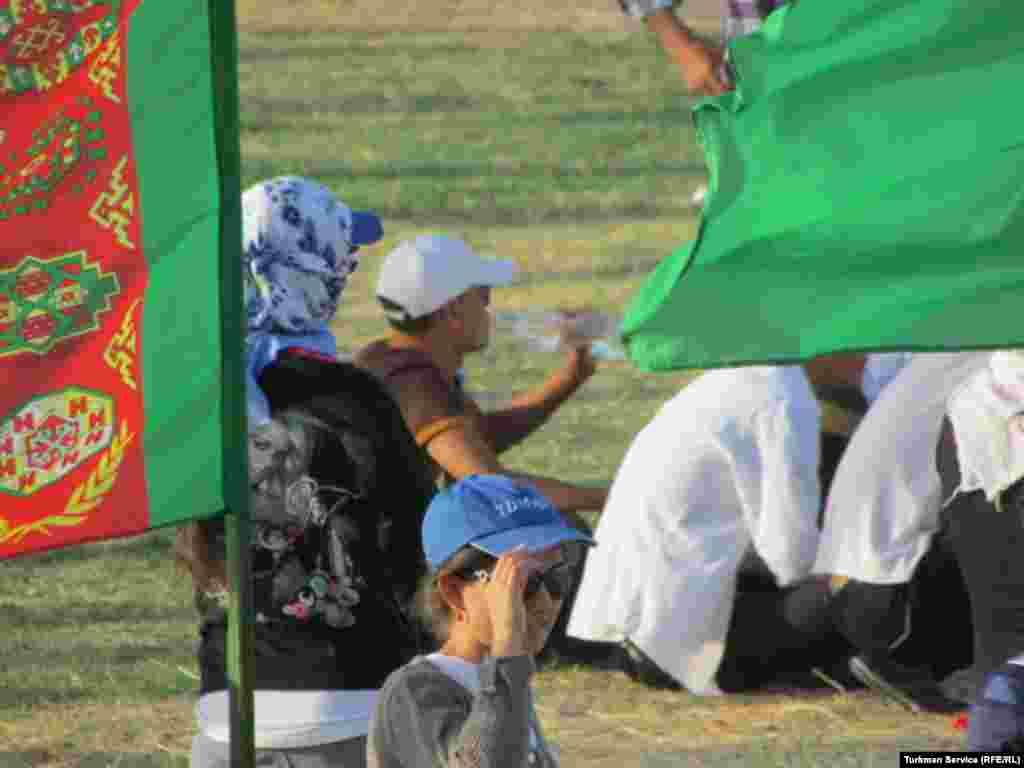 Participants in Turkmenistan's Independence Day celebrations take a break during rehearsals at Turkmenebat's Labor Stadium.