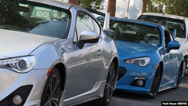 Expensive imported cars are seen at a customs depot. Those who can afford, prefer not to rely on inferior domestic cars.