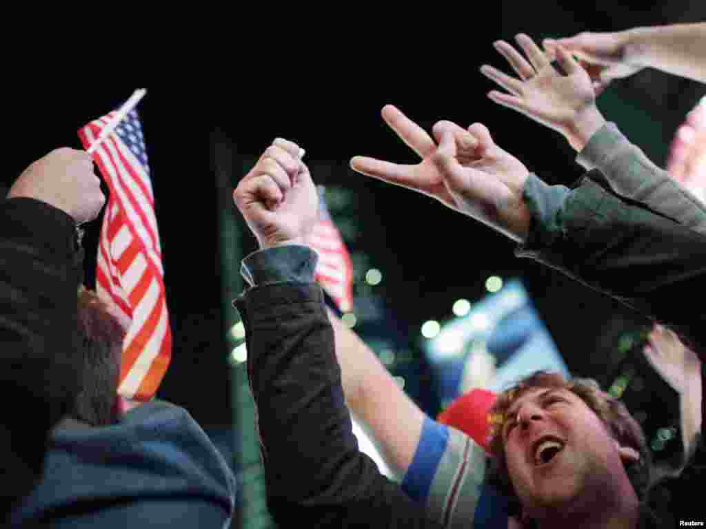 People celebrate the news in New York's Times Square.