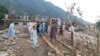 Residents look at the destruction in the aftermath of flash floods in Swat, a district in the northwestern Khyber Pakhtunkhwa Province.