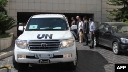 A convoy of United Nations vehicles leaves a hotel in Damascus on August 28 carrying UN inspectors traveling to a site in the Syrian capital of alleged chemical weapons attacks.