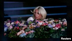 Singer Lady Gaga is displayed on a videowall while fans light their phones during the opening ceremony of the 1st European Games in Baku, Azerbaijan, June 12 , 2015. REUTERS/Stoyan Nenov