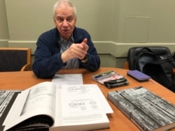 Aleksandr Guryanov, a Katyn researcher, with his three-volume book that lists the names and biographies of 6,287 Polish inmates of the Ostashkov camp.