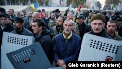 Opposition protesters secure their protest tent camp set up near the Ukrainian parliament building in Kyiv on October 18.