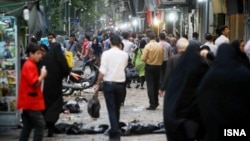 People strolling in the street in downtown of Tehran, undated.