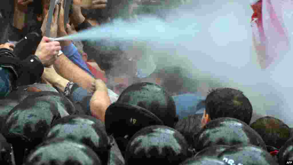 Ukrainian opposition protesters clash with riot police on June 5 in front of the parliament in Kyiv. The demonstrators were protesting against legislation expanding the use of the Russian language in courts and hospitals in the country&#39;s eastern regions, which have close ties to Moscow. (AFP/Sergei Supinsky)