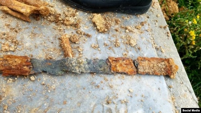 Sword discovered with a skeleton and other artifacts during COVID-19 burial in Iran.