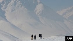 Afghanistan -- Men walk on a snow covered mountain on a cold winter's day outside Kabul, 07Feb2013