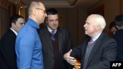 U.S. Senator John McCain (right) speaks to Ukrainian opposition leaders Arseniy Yatsenyuk (left) from and Oleh Tyahnybok during their meeting in Kyiv on December 14.