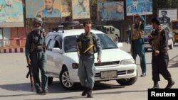 Afghan police keep watch in downtown of Kunduz on October 3.