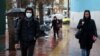 An Iranian man wears protective mask to prevent contracting coronavirus, as he walks in the street in Tehran, February 25, 2020