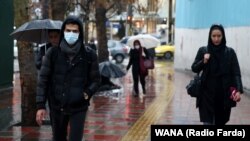 An Iranian man wears protective mask to prevent contracting coronavirus, as he walks in the street in Tehran, February 25, 2020