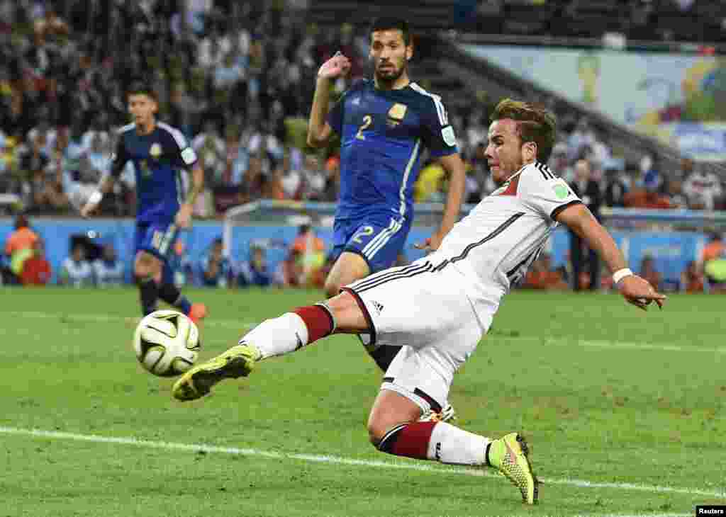 Brazil -- Germany's Mario Goetze shoots to score a goal against Argentina during extra time in their 2014 World Cup final at the Maracana stadium in Rio de Janeiro July 13, 2014. 