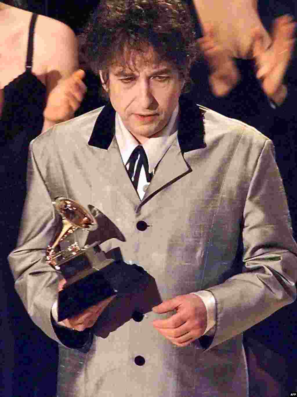 Dylan holds his Grammy after winning Album of the Year for Time Out Of Mind in 1998.