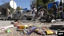 Locals inspect the site of a bomb explosion in Herat on August 15.