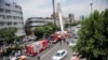 Iran -- An Iranian man attempts to commit suicide by leaping from a communication's pole in central Tehran in protest at the corruption and poverty that are rife in the regime, July 8, 2014