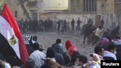 Protesters and riot police face off near Tahrir Square in Cairo on November 21.