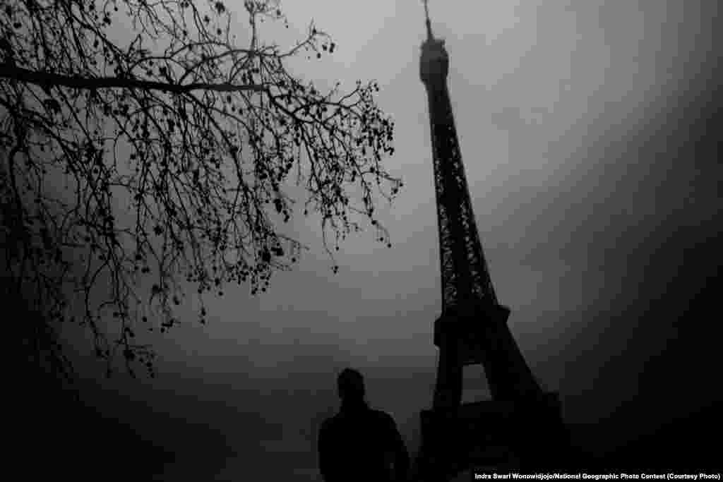 HONORABLE MENTION: Eerie Eiffel (Paris, France) -- The winter gloomy day worked to my advantage to create this eerie feeling of the famous landmark Eiffel Tower. (Caption by photographer Indra Swari Wonowidjojo)