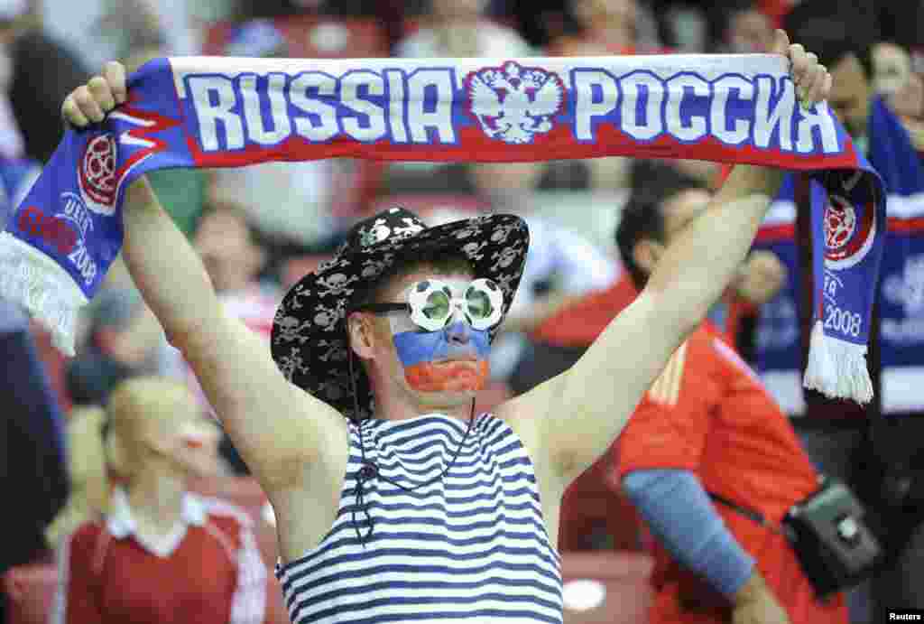 Russia&#39;s soccer fan cheers during the match against Poland in Warsaw.