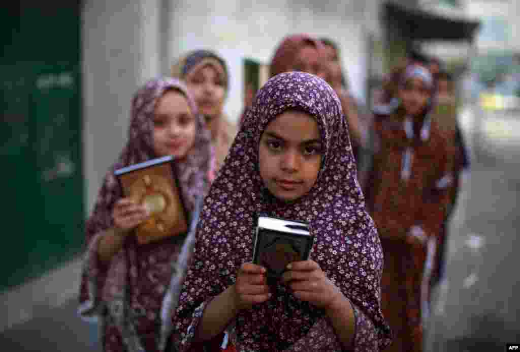 Palestinian girls arrive to read verses from the Koran during a class on how to read the holy book of Islam at a mosque in Gaza City. (AFP/Mohammed Abed)