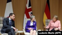 Франция президенти Эммануэл Макрон, британ премьери Тереза Мэй жана немис канцлери Ангела Меркел. Брюссель. 22-март, 2018-жыл.