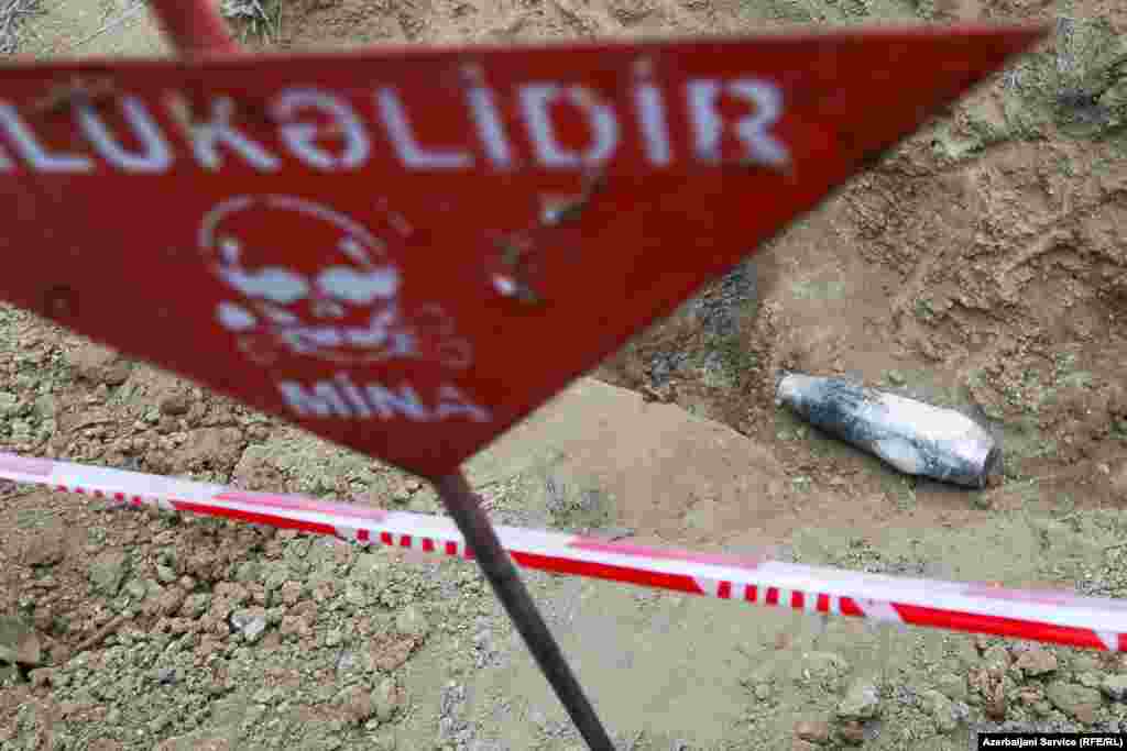 A phosphorus shell that Azerbaijani authorities say was left behind by ethnic Armenian forces lies cordoned off from onlookers. 