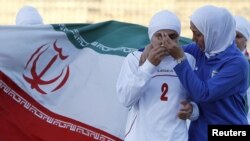 An Iranian women's national soccer player is comforted in Amman by a teammate after withdrawing from their June qualifying match against Jordan for the 2012 London Olympic Games.