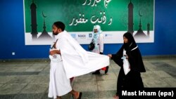 Muslim worshippers arrive at the hajj terminal of the King Abdulaziz international airport in Jeddah on August 27.