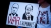 A poster depicts Russian President Vladimir Putin and Belarusian authoritarian leader Alyaksandr Lukashenka with the words "War Criminals" at a protest against Russia's invasion of Ukraine, in London in March 2022.