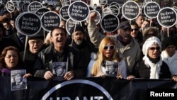 Friends of slain Turkish-Armenian journalist Hrant Dink march with placards that read: "This case won't end this way," during a demonstration near a courthouse in Istanbul on January 17. 