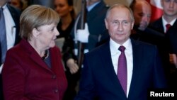 German Chancellor Angela Merkel (left) welcomes Russian President Vladimir Putin to Berlin on October 19.