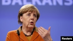 German Chancellor Angela Merkel addresses a news conference after a meeting over the Balkan refugee crisis with leaders from Central and Eastern Europe at the EU Commission headquarters in Brussels on October 26.