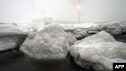 Gas flares off under heavy snowfall at a liquefied natural gas (LNG) plant on Sakhalin island outside the town of Korsakov 