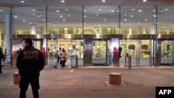 US -- A New York City Department of Health and Hospitals Police (NYHP) officer walks past the entrance to Bellevue Hospital October 23, 2014 after a doctor who recently returned to New York from West Africa was rushed with a fever t o be tested for pos