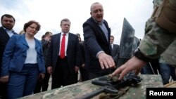 Georgian President Georgi Margvelashvili (right), Prime Minister Georgi Kvirikashvili (center), and Defense Minister Tinatin Khidasheli examine military gear during the opening of the U.S.-led joint military exercise Noble Partner 2016 in Vaziani, Georgia, in May.