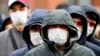 RUSSIA -- Migrant workers wearing protective face masks queue outside a migration control center to prolong their stay in Russia amid the ongoing coronavirus pandemic in St. Petersburg, April 3, 2020