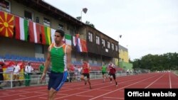 Iraqi paralympic athlete Fadhil Razzaq Abdulameer crosses the finish line to win gold in the 100 meters