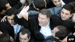 Georgia - Tbilisi mayor Gigi Ugulava (C) gestures as he scuffles with protesters in Tbilisi, 08Feb2013