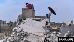 A photo released by the Syrian official news agency SANA shows the rubble of a house that according to the Syrian authorities was attacked by an Israeli airstrike, in the Damascus suburbs of Hajira, April 27, 2020