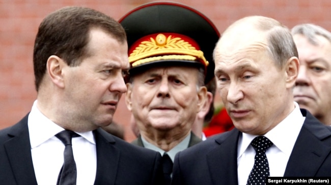 Then-Prime Minister Dmitry Medvedev (left) with Vladimir Putin in 2013.