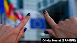 BELGIUM -- A woman shows her finger nails colored in the European colours in front of the European Parliament building in Brussels, May 24, 2019