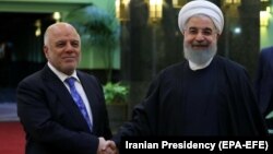 Președintele iranian Hassan Rohani (dreapta) și premierul irakian Haidar al-Abadi, Teheran, octombrie 2017