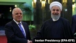 Iranian President Hassan Rohani (right) meets with Iraqi Prime Minister Haidar al-Abadi in Tehran on October 26.