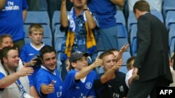 U.K. -- Chelsea Football Club owner Roman Abramovich (R) greets fans on the pitch at the Stamford Bridge Stadium, London, 23Aug2003