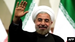 Президент Ирана Хасан Роухани приветствует своих сторонников в Тегеране. 15 июня 2013 года. 