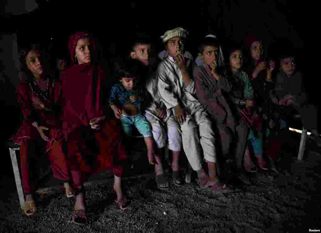 Afghan refugee children, returning from Pakistan, watch a short video clip about mines at a mines and explosives awareness program at a United Nations High Commissioner for Refugees registration center in Kabul. (Reuters/Ahmad Masood)