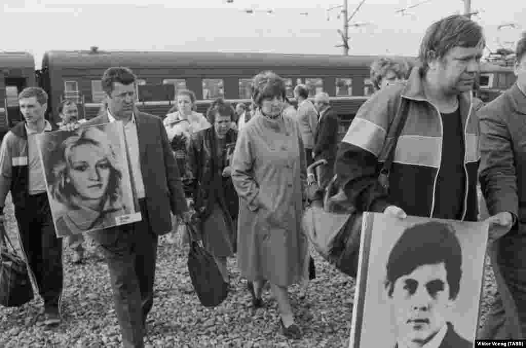 Relatives and friends of the disaster commemorate the victims at the site of the explosion on the first anniversary on June 4, 1990.